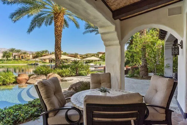 a view of swimming pool with outdoor seating and plants