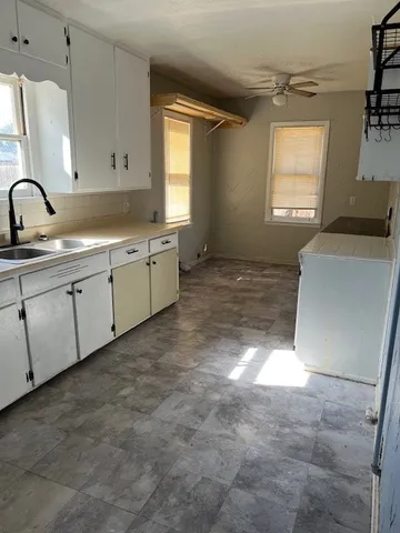a kitchen with a sink stove and cabinets