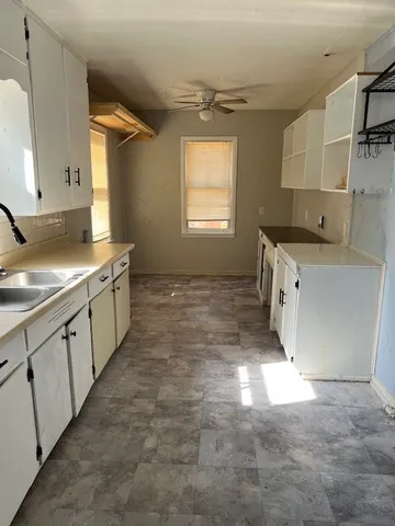 a view of a refrigerator in wooden floor