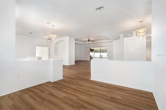 a view of kitchen and hall with wooden floor
