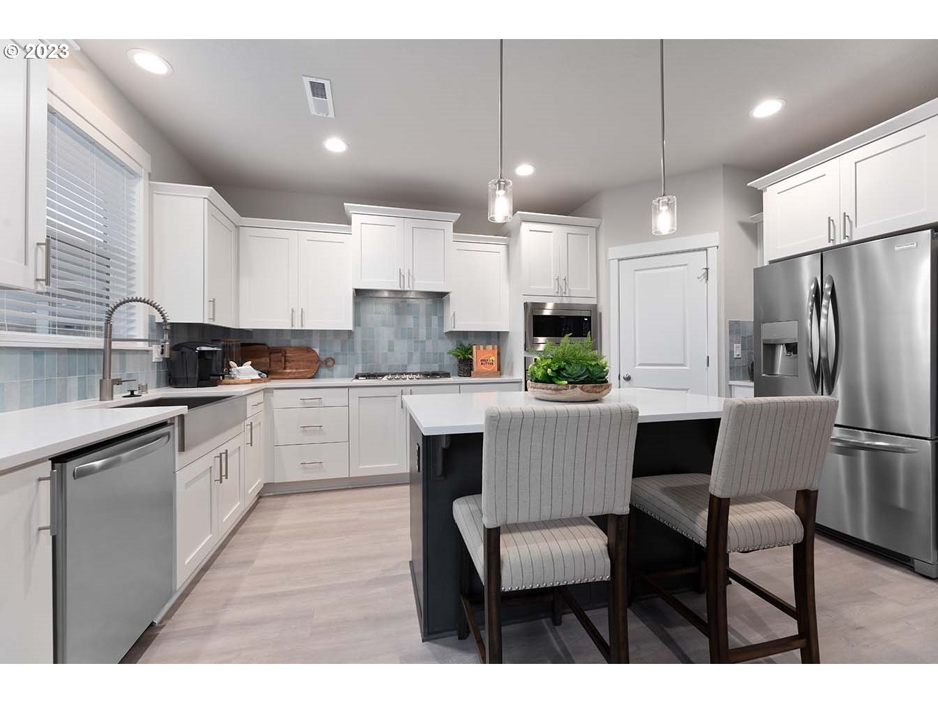8903 North 5th Street, Unit 63 Ridgefield, WA 98642 - Photo 2 of 32 a kitchen with a refrigerator a table and chairs in it
