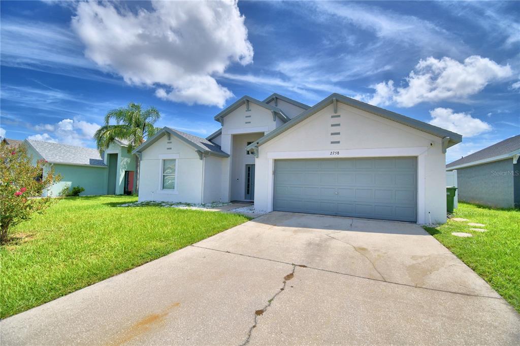 a front view of house with yard and trees