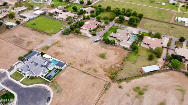 an aerial view of a house with a swimming pool and outdoor space