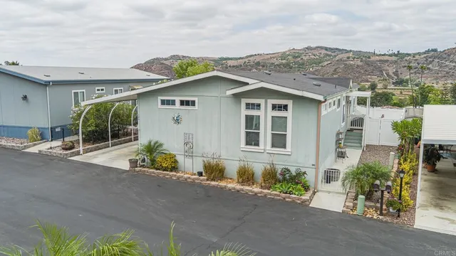 a front view of a house with a garden and yard