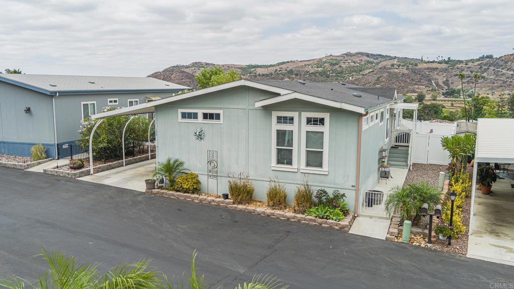 a front view of a house with a garden and yard
