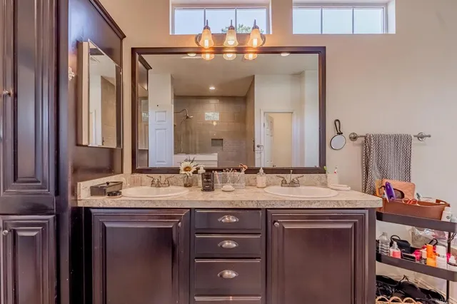 a bathroom with a granite countertop sink vanity and a mirror