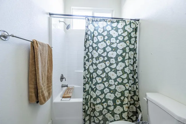 a bathroom with a shower curtain and a sink