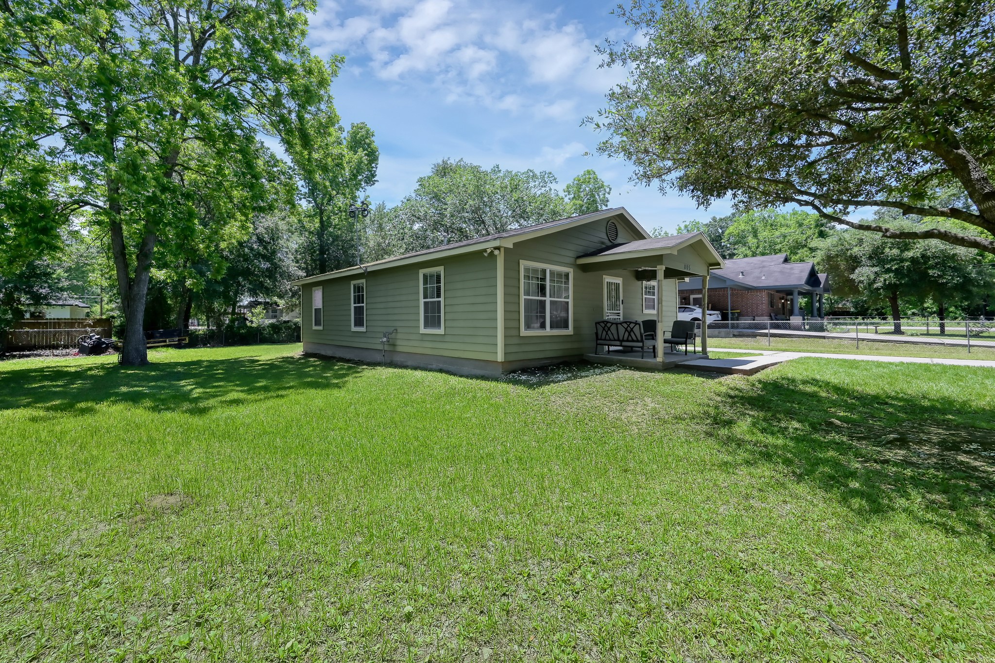 805 Webb Street Conroe, TX 77301 - Photo 3 of 19 a front view of a house with a garden and trees