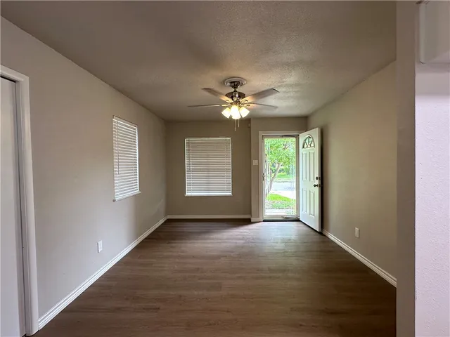 a view of an empty room with a window