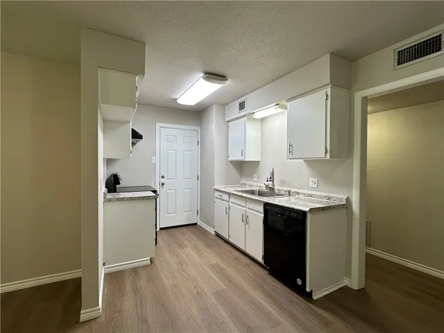 a kitchen with a sink stove and cabinets