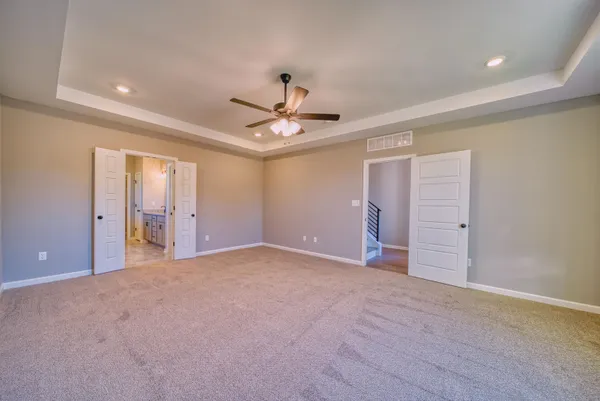 a view of a hallway with wooden floor and entryway