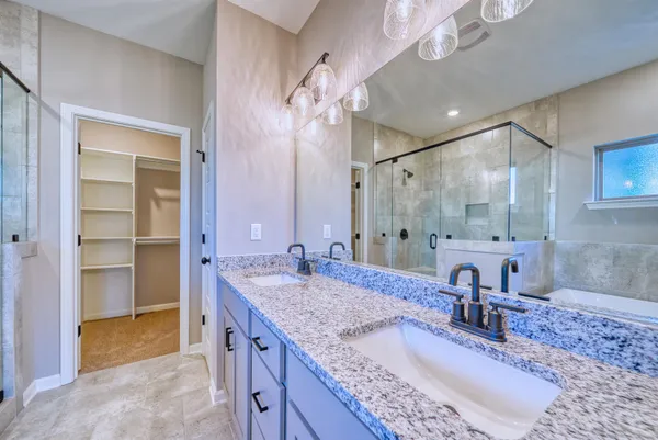 a bathroom with a granite countertop sink a toilet and bathtub
