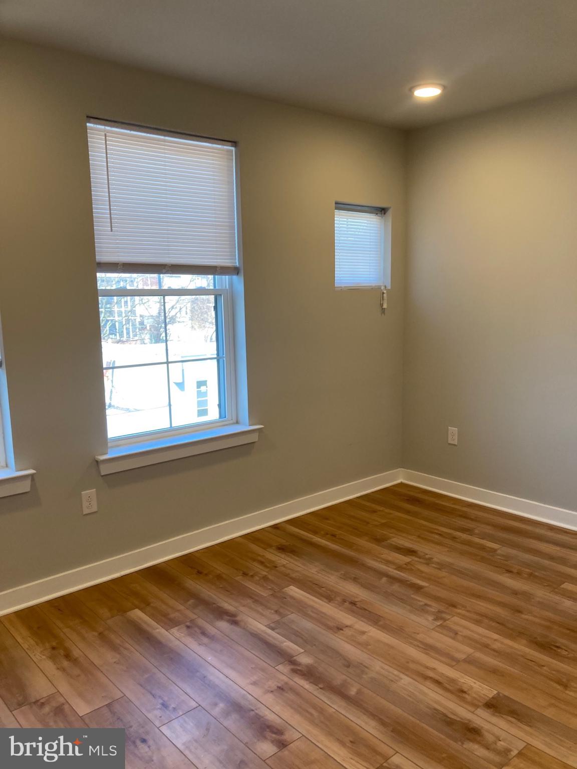 2553 North Front Street, Unit 3 Philadelphia, PA 19133 - Photo 12 of 16 a view of an empty room with wooden floor and a window