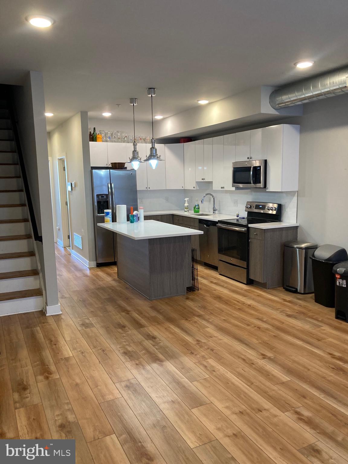 2553 North Front Street, Unit 3 Philadelphia, PA 19133 - Photo 3 of 16 a large kitchen with stainless steel appliances granite countertop a stove and a sink