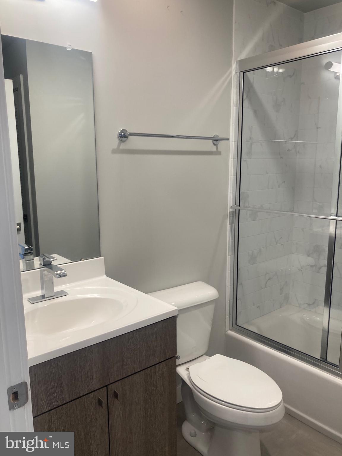 2553 North Front Street, Unit 3 Philadelphia, PA 19133 - Photo 9 of 16 a white toilet sitting next to a bathroom sink