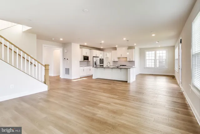 a view of kitchen dining table chairs microwave and cabinets