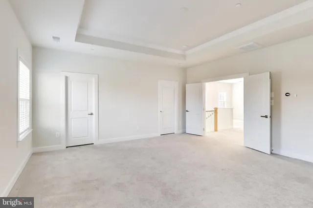 a view of an empty room and closet area