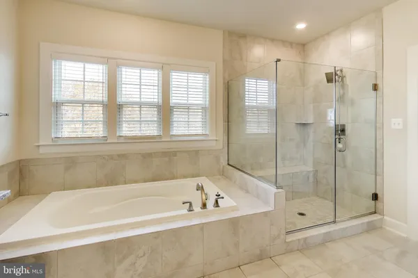 a bathroom with a bathtub and a shower