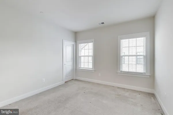 a bathroom with a granite countertop tub sink and mirror