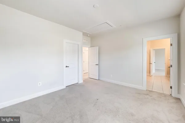 a view of kitchen with stainless steel appliances kitchen island sink refrigerator and microwave