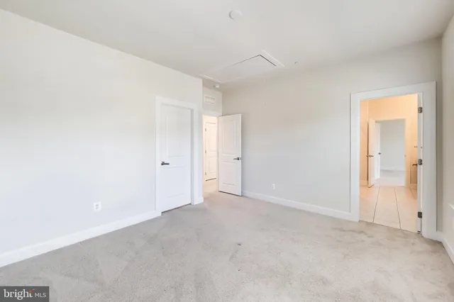 a view of kitchen with stainless steel appliances kitchen island sink refrigerator and microwave