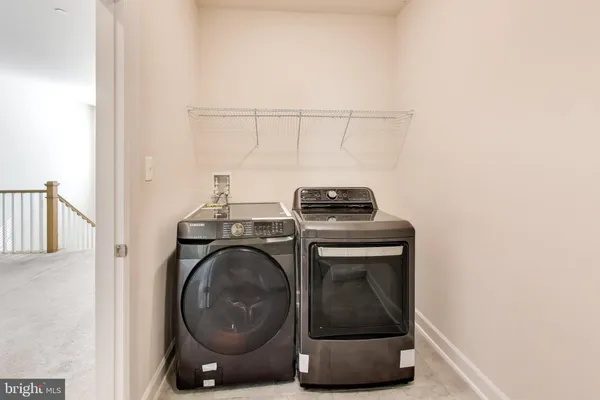 a large room with stainless steel appliances kitchen island granite countertop a refrigerator and a stove top oven