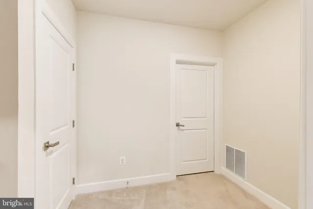 an empty room with a ceiling fan and a window