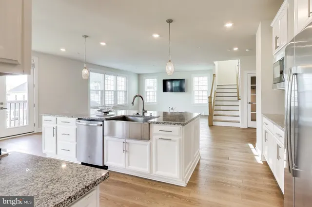 a large white kitchen with a large window