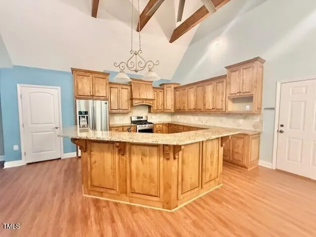 a kitchen with stainless steel appliances granite countertop a sink and a refrigerator