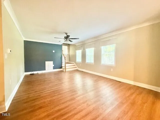 a kitchen with stainless steel appliances granite countertop a sink cabinets and wooden floor
