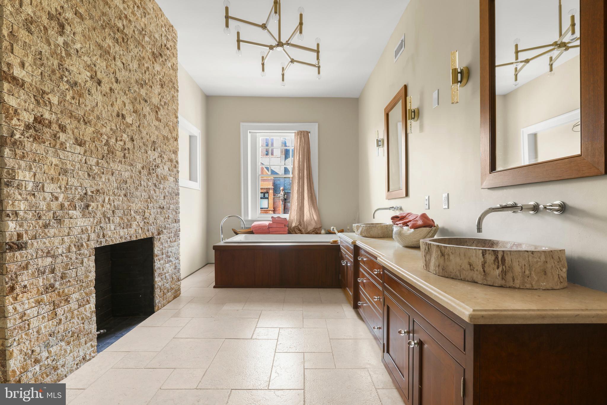 1007 North Calvert Street Baltimore, MD 21202 - Photo 24 of 43 a bathroom with a tub sink and mirror