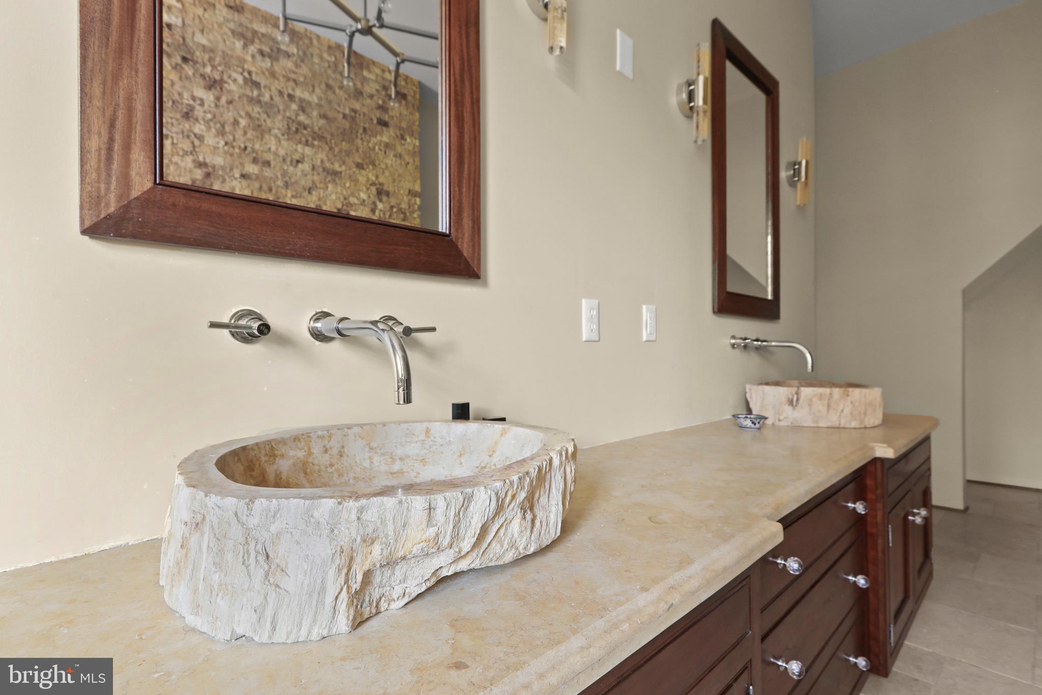 1007 North Calvert Street Baltimore, MD 21202 - Photo 27 of 43 a bathroom with a tub sink and mirror