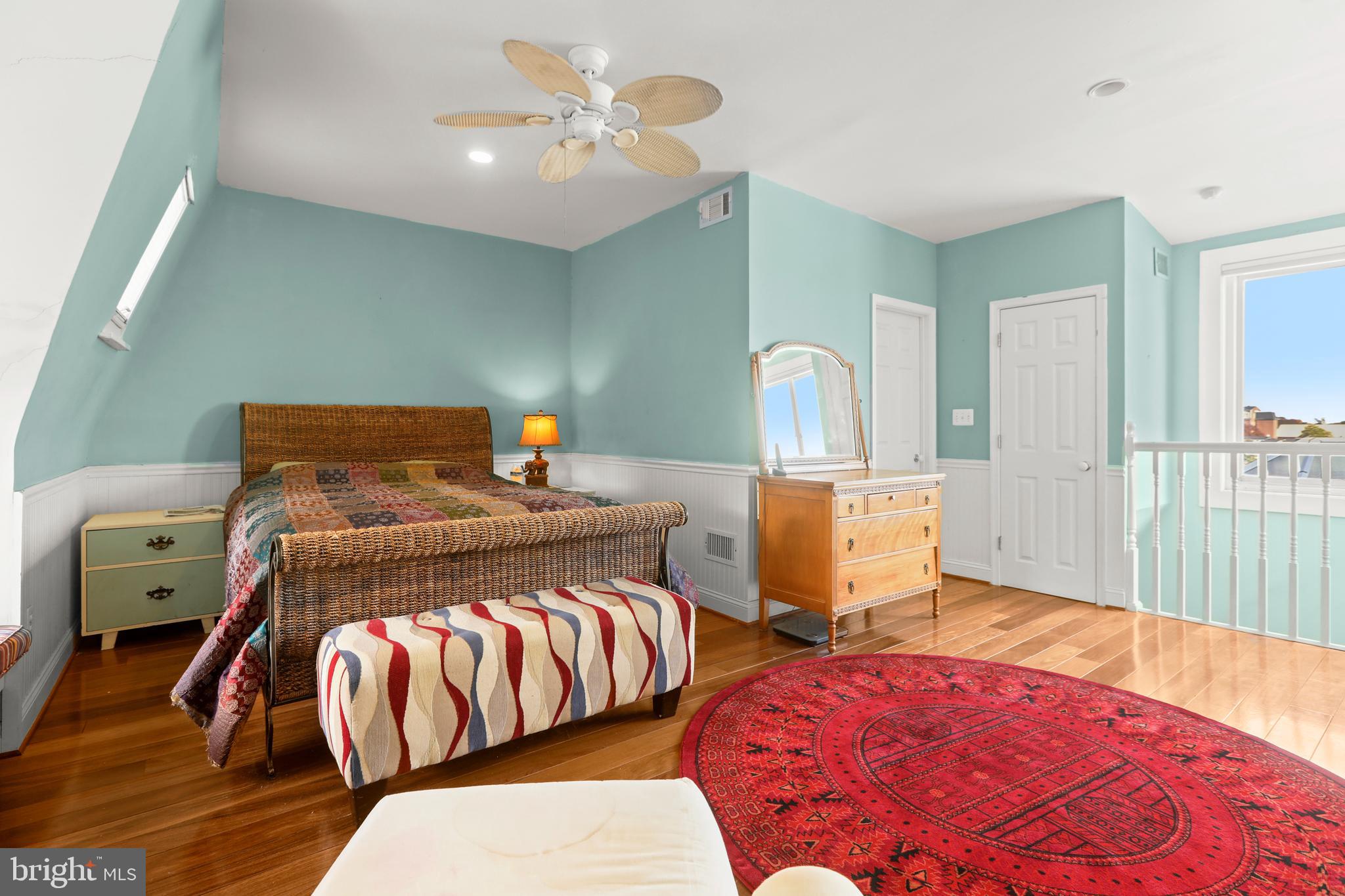 1007 North Calvert Street Baltimore, MD 21202 - Photo 30 of 43 a bedroom with a bed and wooden floor