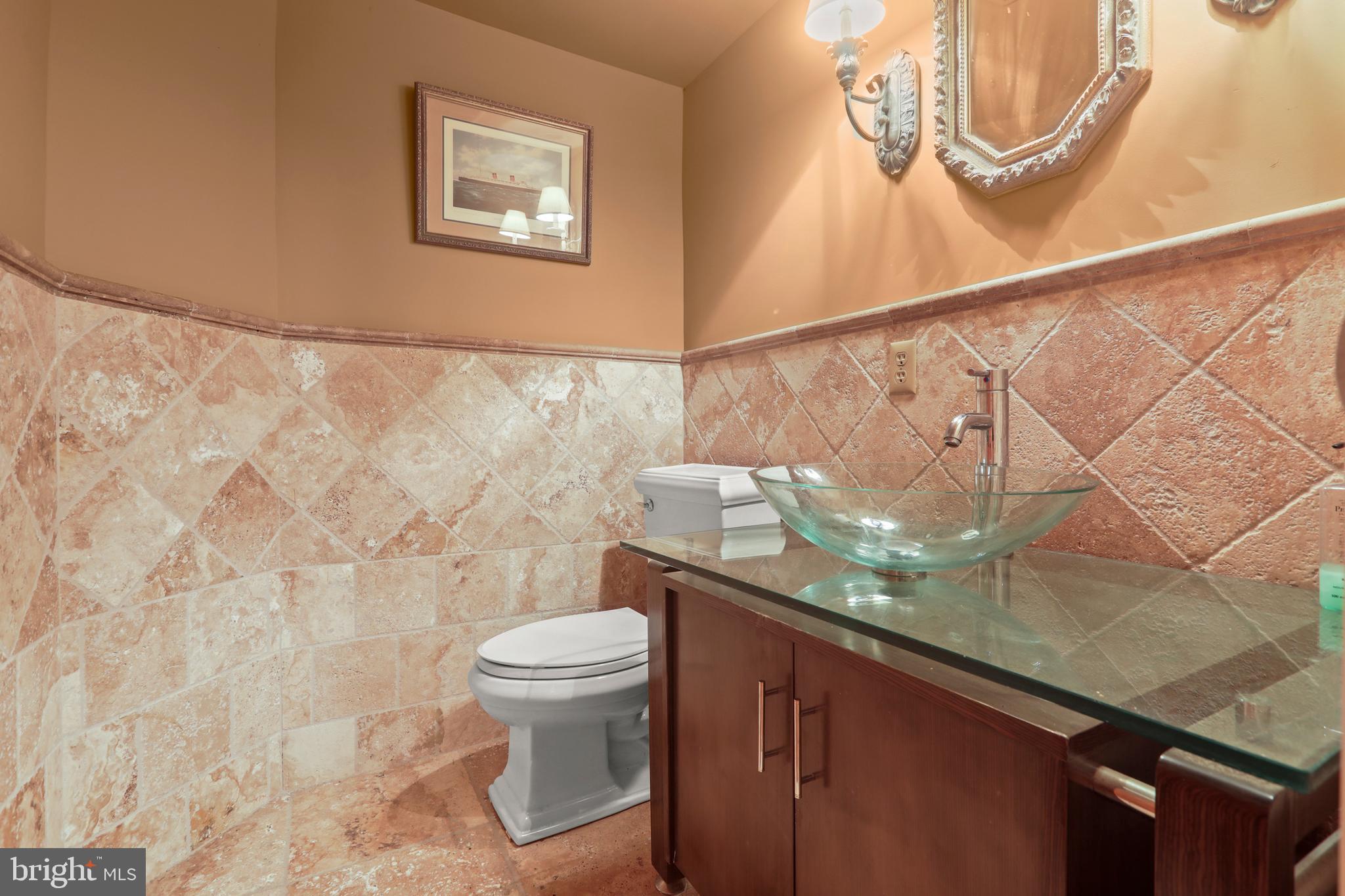 1007 North Calvert Street Baltimore, MD 21202 - Photo 35 of 43 a bathroom with a granite countertop sink and a toilet