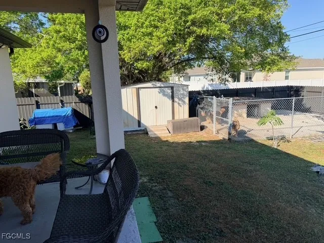 a view of backyard with a patio and a fire pit
