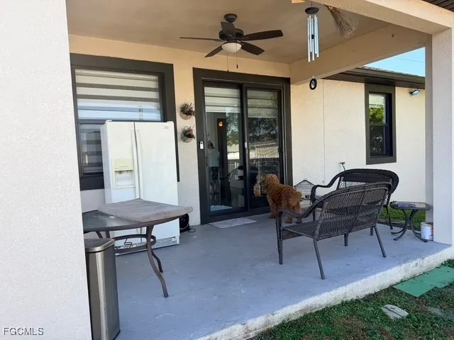 a patio with a table and chairs