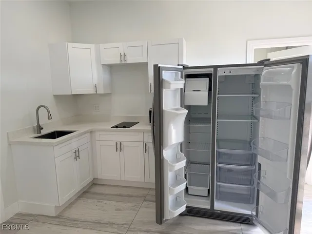 a kitchen with a sink and refrigerator