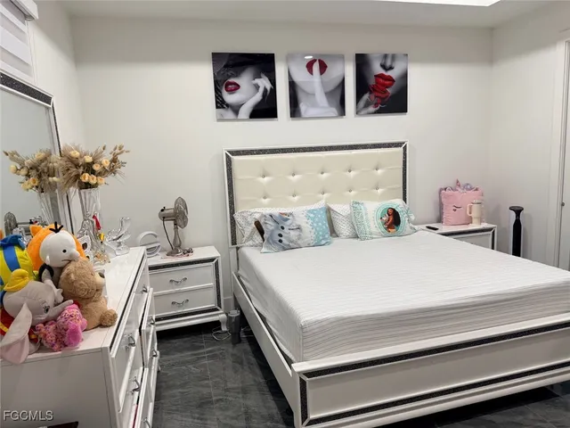 a bedroom with a bed and a potted plant