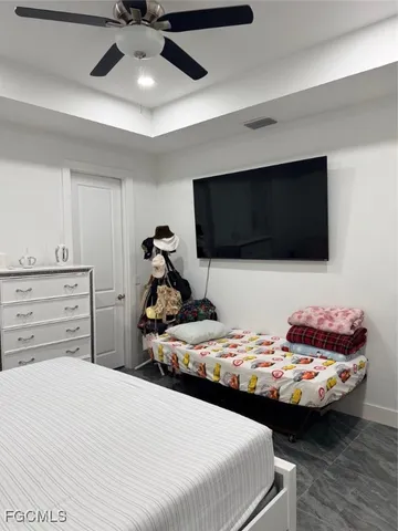 a bedroom with bed and tv