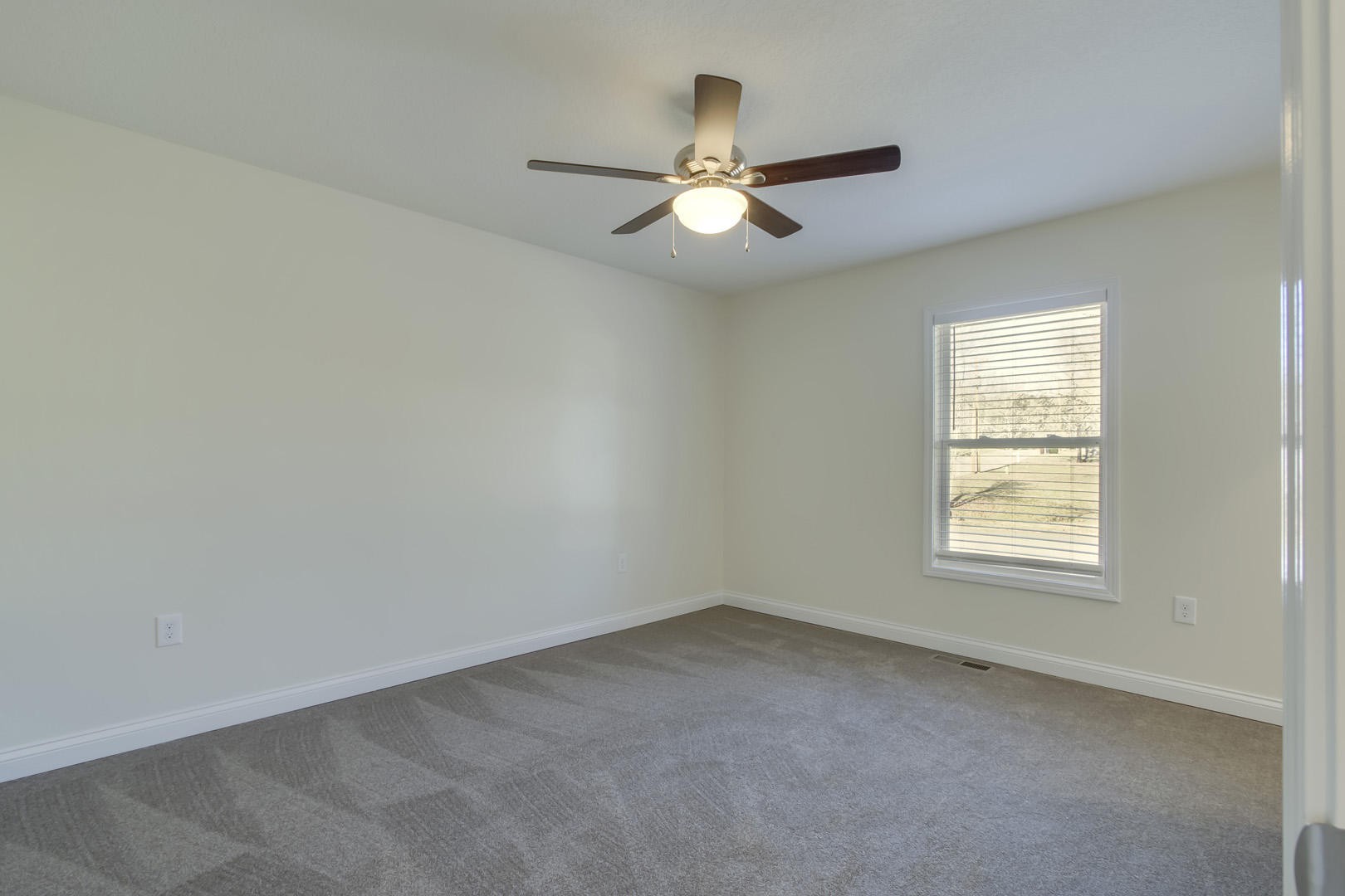 223 Butler Road Oak Ridge, TN 37830 - Photo 16 of 27 an empty room with a window and a fan