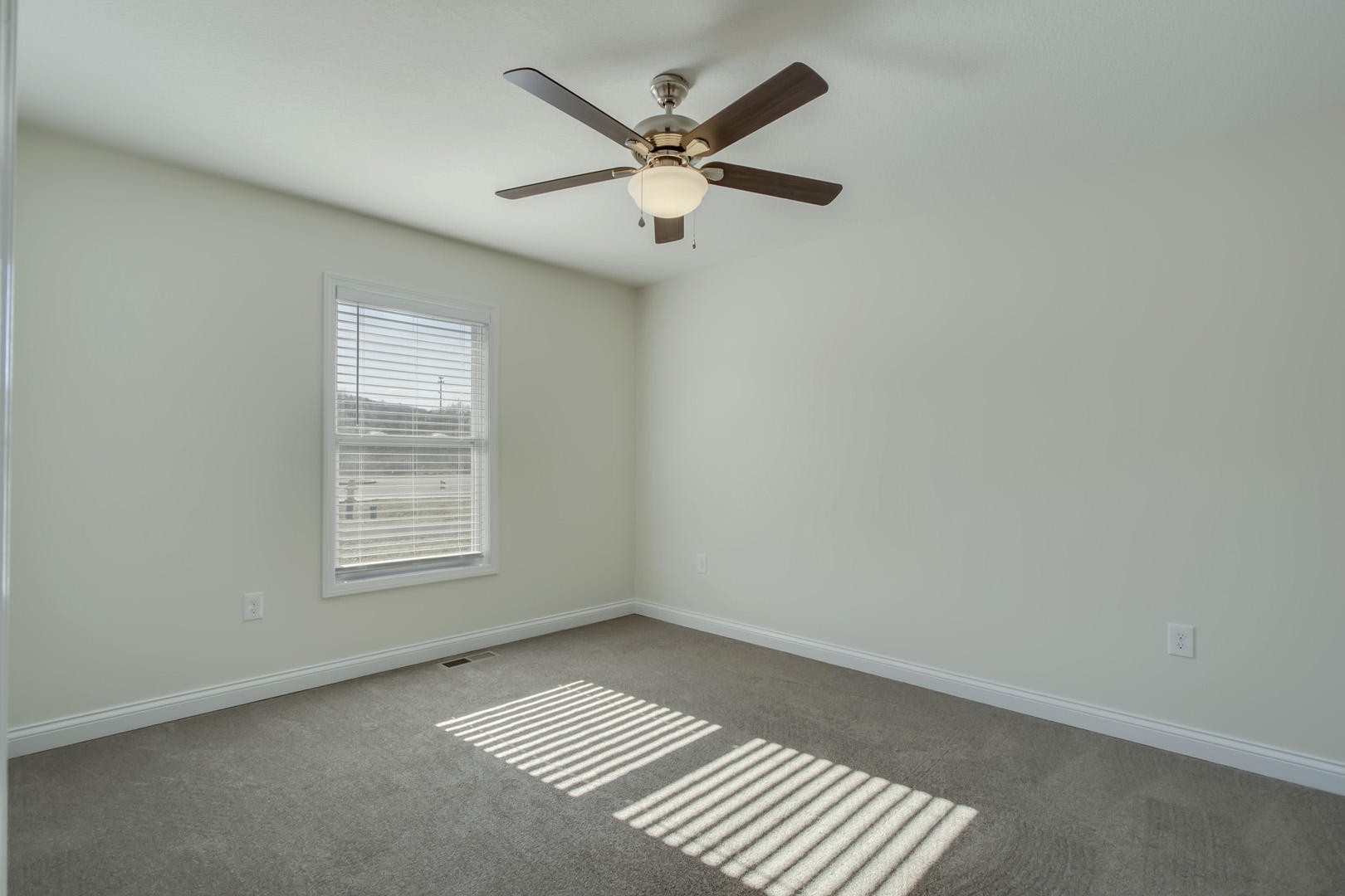 223 Butler Road Oak Ridge, TN 37830 - Photo 19 of 27 an empty room with wooden floor ceiling fan and windows