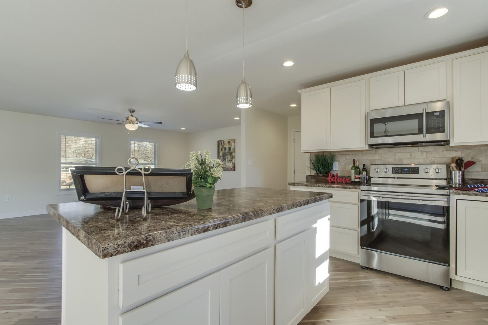 223 Butler Road Oak Ridge, TN 37830 - Photo 8 of 27 a kitchen with stainless steel appliances granite countertop a stove top oven a sink and dishwasher