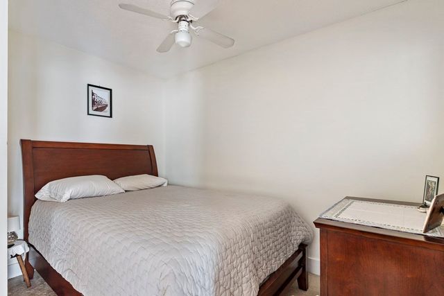 a bedroom with a bed and cabinets