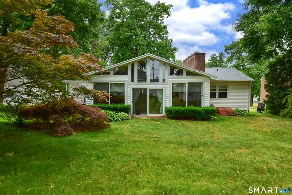 a front view of a house with a garden