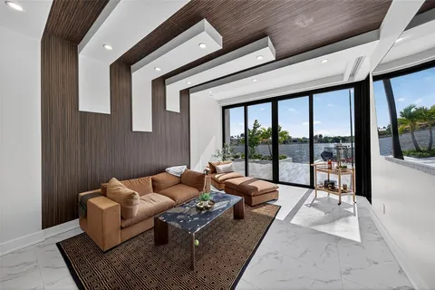 a view of a dining room with furniture large windows and wooden floor