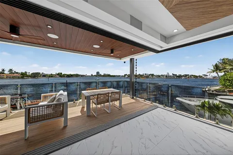 a large kitchen with stainless steel appliances granite countertop a lot of counter space and a sink