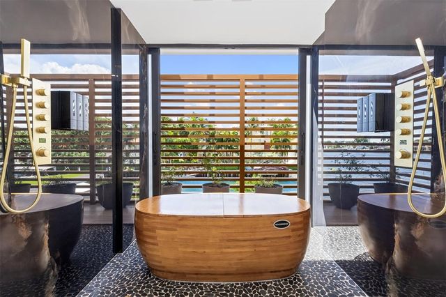 a living room with furniture and floor to ceiling windows