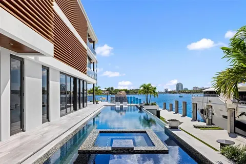 a living room with fireplace furniture and a potted plant