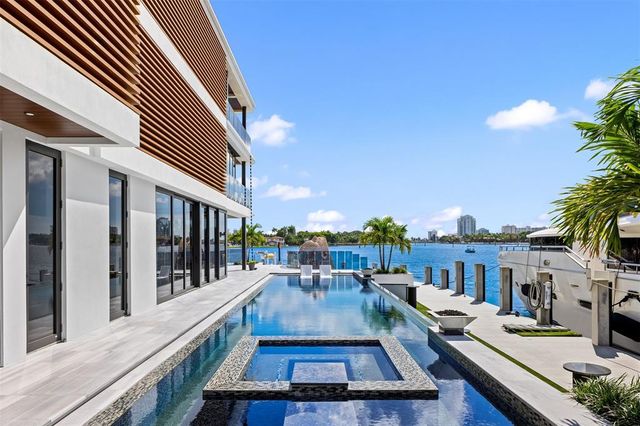 a living room with fireplace furniture and a potted plant