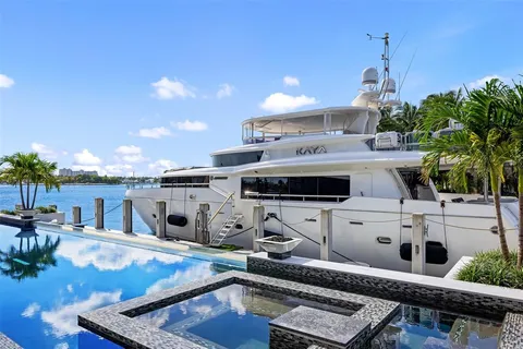 a view of a house with pool and a yard
